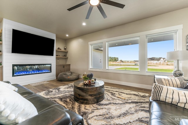 6623 Red Rock Rd, Marsing, ID 83639 - living area featuring ceiling fan, baseboards, wood finished floors, a glass covered fireplace, and recessed lighting