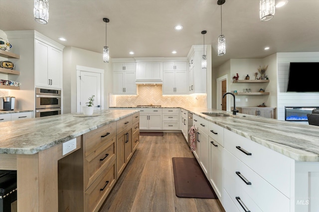 6623 Red Rock Rd, Marsing, ID 83639 - kitchen featuring a sink, open shelves, appliances with stainless steel finishes, a peninsula, and recessed lighting