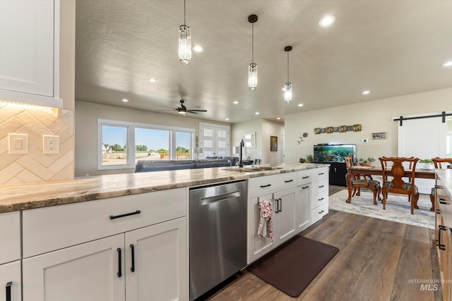 6623 Red Rock Rd, Marsing, ID 83639 - kitchen featuring stainless steel dishwasher, a sink, open floor plan, dark wood-type flooring, and a barn door