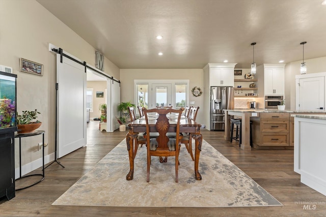 6623 Red Rock Rd, Marsing, ID 83639 - dining space with a barn door, recessed lighting, and dark wood-style flooring