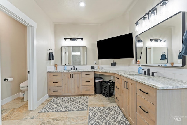 6623 Red Rock Rd, Marsing, ID 83639 - full bathroom featuring toilet, vanity, baseboards, and stone finish flooring