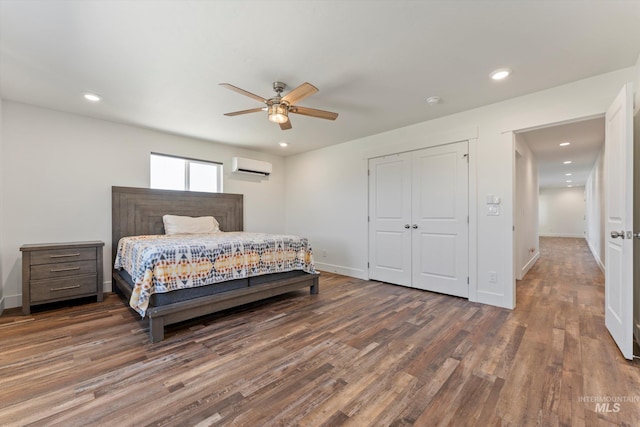 6623 Red Rock Rd, Marsing, ID 83639 - bedroom featuring a wall unit AC, wood finished floors, baseboards, a closet, and a ceiling fan