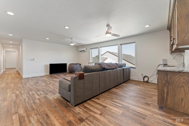 6623 Red Rock Rd, Marsing, ID 83639 - living room featuring light wood-style floors, a ceiling fan, baseboards, a wall mounted AC, and recessed lighting