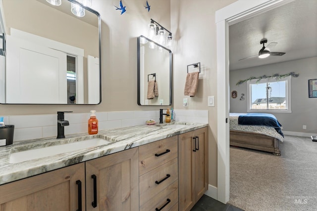 6623 Red Rock Rd, Marsing, ID 83639 - ensuite bathroom with double vanity, a ceiling fan, and baseboards