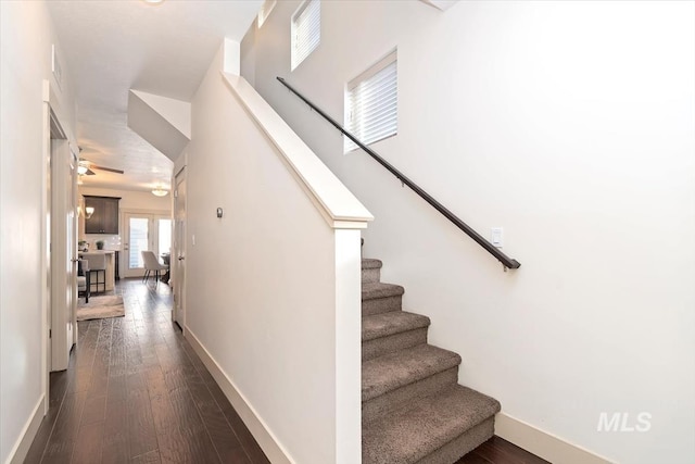 staircase with wood finished floors and baseboards