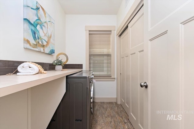 hallway featuring baseboards and washer and clothes dryer