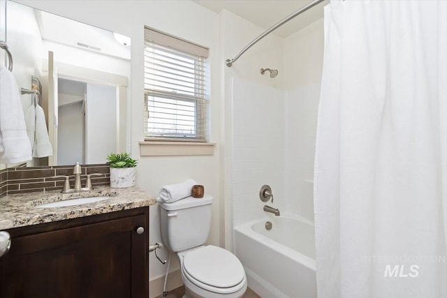 bathroom with visible vents, toilet, vanity, and shower / bathtub combination with curtain