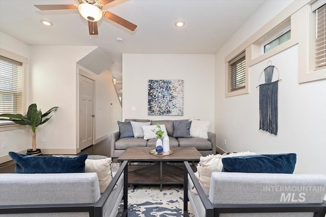 living area with a ceiling fan, recessed lighting, and baseboards