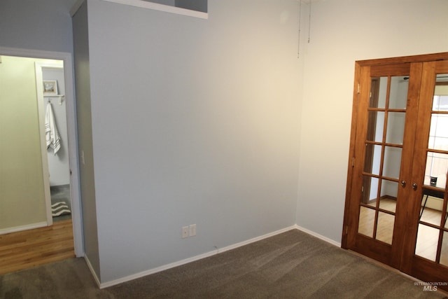 225 E Bayview, Boise, ID 83706 - empty room featuring french doors, dark carpet, and baseboards