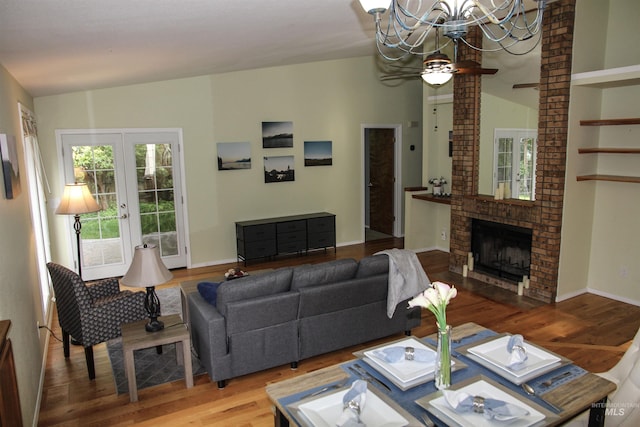 225 E Bayview, Boise, ID 83706 - living area with a chandelier, wood finished floors, lofted ceiling, a brick fireplace, and a ceiling fan