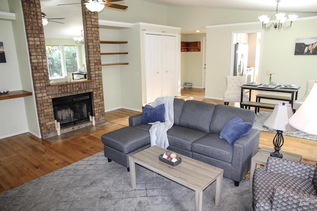 225 E Bayview, Boise, ID 83706 - living area featuring a ceiling fan, wood finished floors, a chandelier, a fireplace, and baseboards