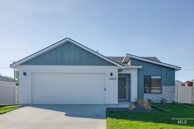 view of front of home with a garage and a front lawn