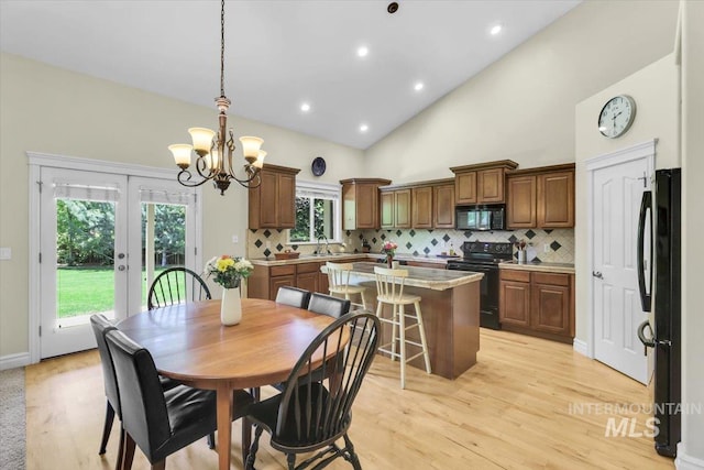 2627 E Moog St, Meridian, ID 83646 - dining room featuring a chandelier, light wood-style floors, french doors, high vaulted ceiling, and recessed lighting