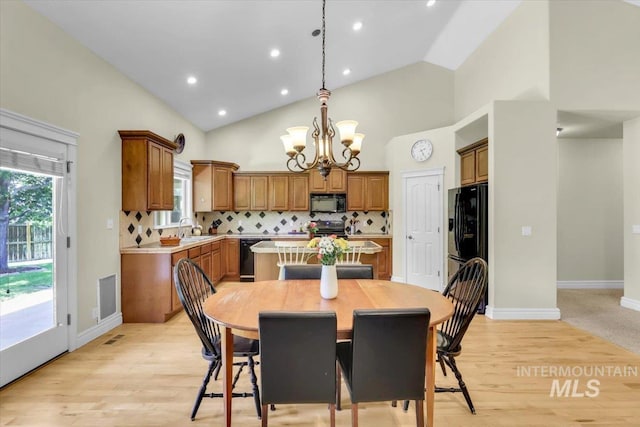 2627 E Moog St, Meridian, ID 83646 - dining area with a chandelier, light wood finished floors, high vaulted ceiling, baseboards, and recessed lighting