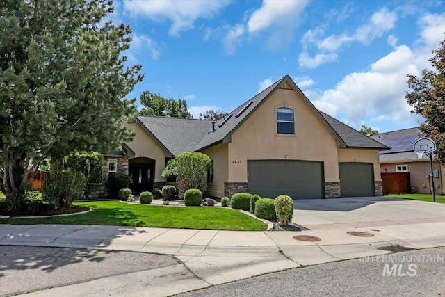 2627 E Moog St, Meridian, ID 83646 - view of front of home with stucco siding, stone siding, a front lawn, and driveway