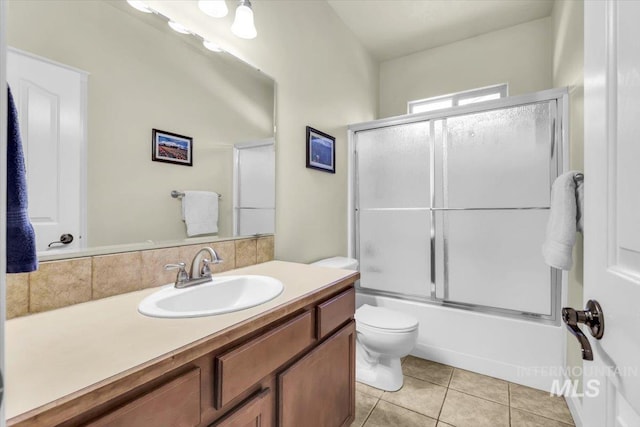 2627 E Moog St, Meridian, ID 83646 - full bathroom with toilet, vanity, tile patterned floors, and bath / shower combo with glass door