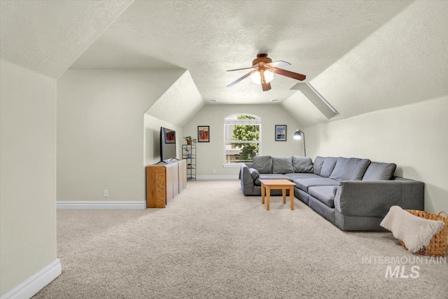 2627 E Moog St, Meridian, ID 83646 - carpeted living area with a textured ceiling, ceiling fan, baseboards, and vaulted ceiling