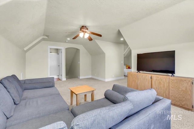 2627 E Moog St, Meridian, ID 83646 - living room featuring light colored carpet, a ceiling fan, a textured ceiling, lofted ceiling, and baseboards
