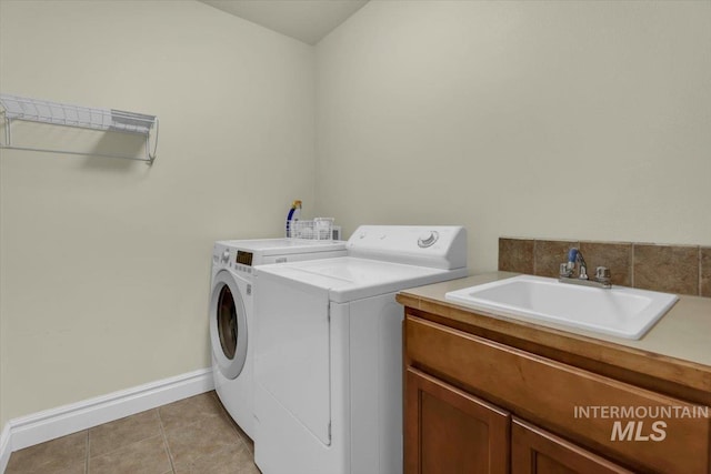2627 E Moog St, Meridian, ID 83646 - laundry room with independent washer and dryer, cabinet space, baseboards, and light tile patterned floors