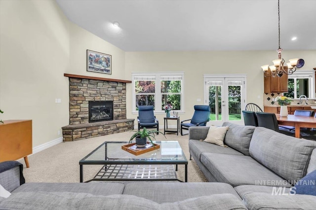 2627 E Moog St, Meridian, ID 83646 - living area featuring a chandelier, carpet, french doors, a stone fireplace, and baseboards
