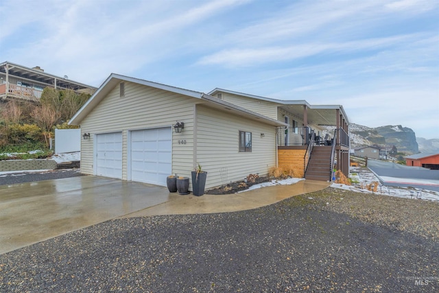 view of property exterior featuring a garage and a mountain view