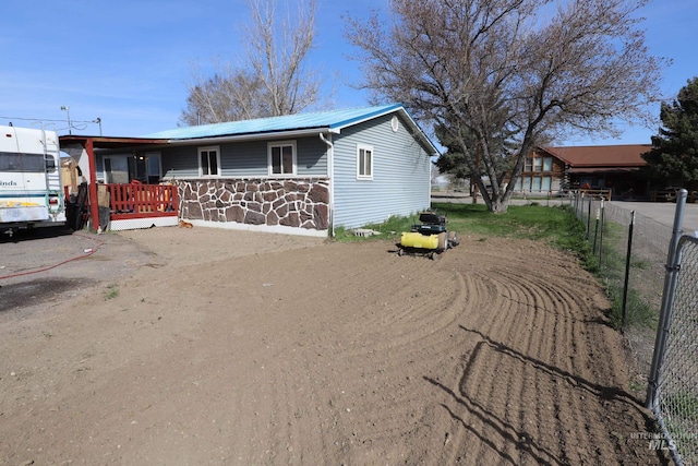 view of front of property with fence and metal roof