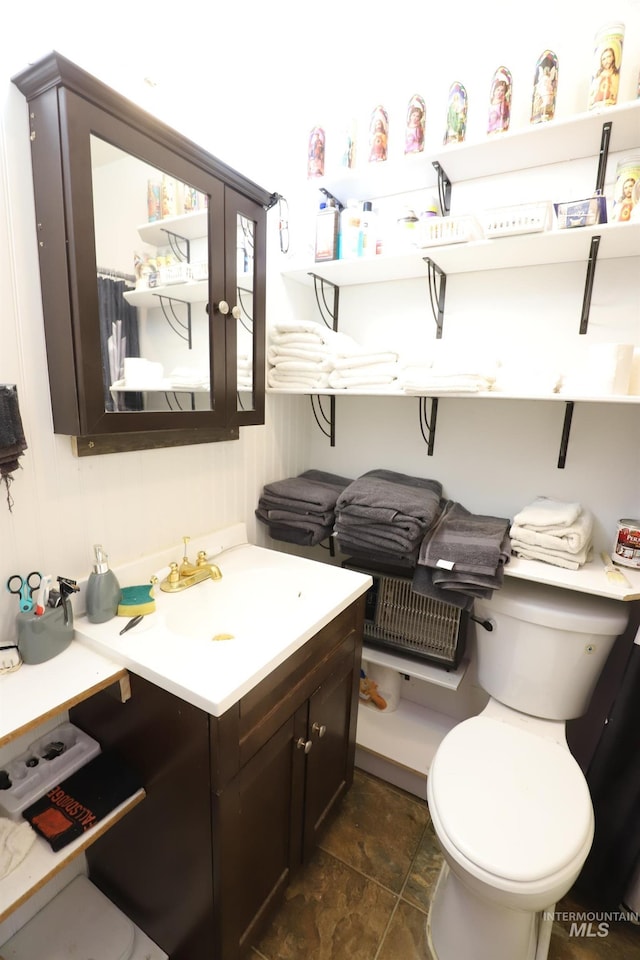 bathroom featuring toilet and vanity