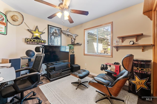 home office featuring baseboards, wood finished floors, and ceiling fan