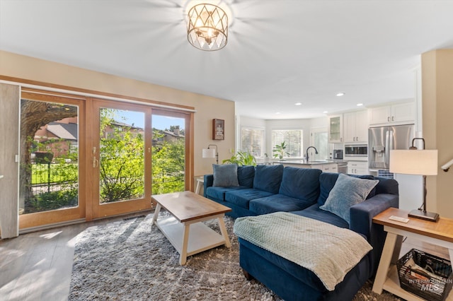 living room featuring wood finished floors, visible vents, and recessed lighting
