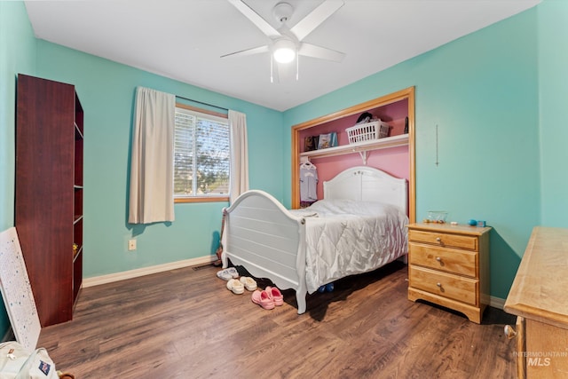 bedroom with visible vents, baseboards, wood finished floors, and ceiling fan