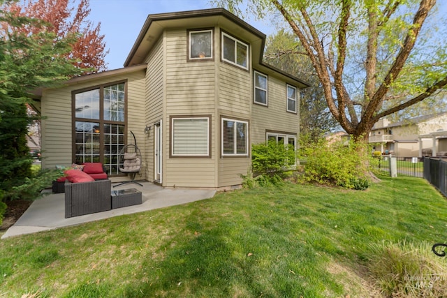 back of house featuring fence, a yard, and a patio