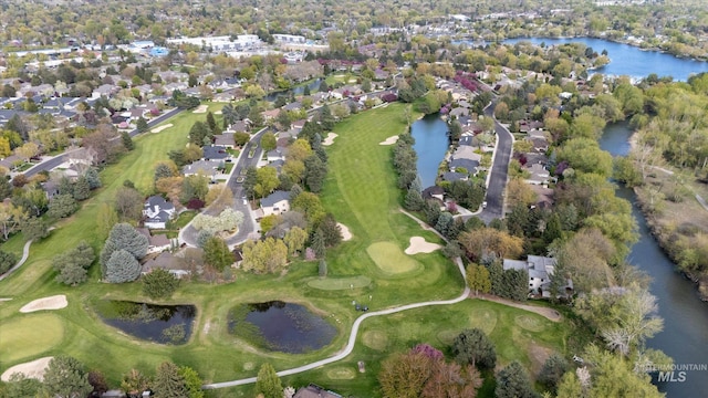 drone / aerial view featuring a residential view, golf course view, and a water view