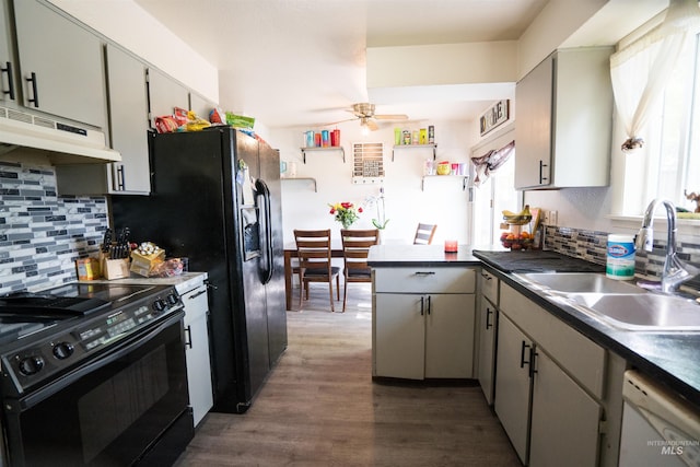 kitchen featuring dishwasher, sink, backsplash, black electric range, and ceiling fan