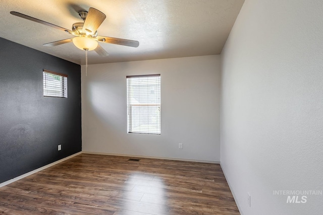 9885 W Tilmont St, Boise, ID 83709 - empty room featuring wood finished floors, ceiling fan, baseboards, and a textured ceiling