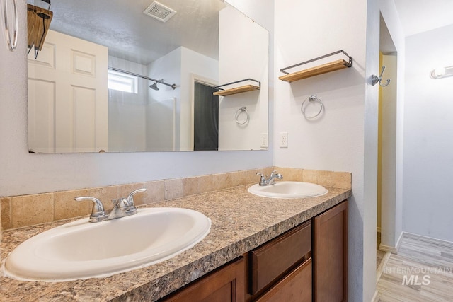 9885 W Tilmont St, Boise, ID 83709 - full bathroom featuring double vanity and a shower