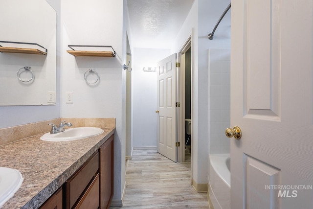 9885 W Tilmont St, Boise, ID 83709 - full bath featuring wood finished floors, double vanity, and baseboards