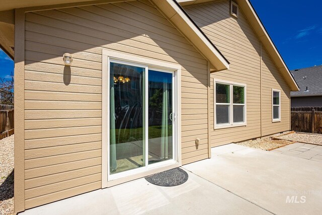 9885 W Tilmont St, Boise, ID 83709 - back of house with a patio and a fenced backyard