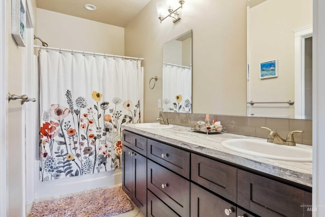 full bath featuring double vanity, a shower with curtain, a sink, and backsplash