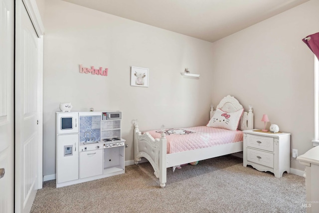 bedroom featuring light carpet and baseboards