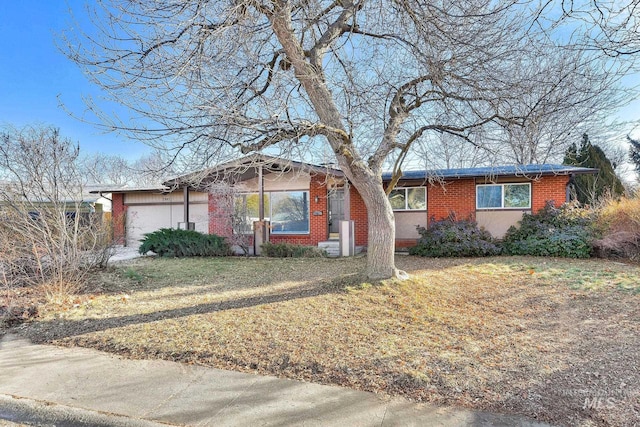 single story home featuring a garage and a front yard