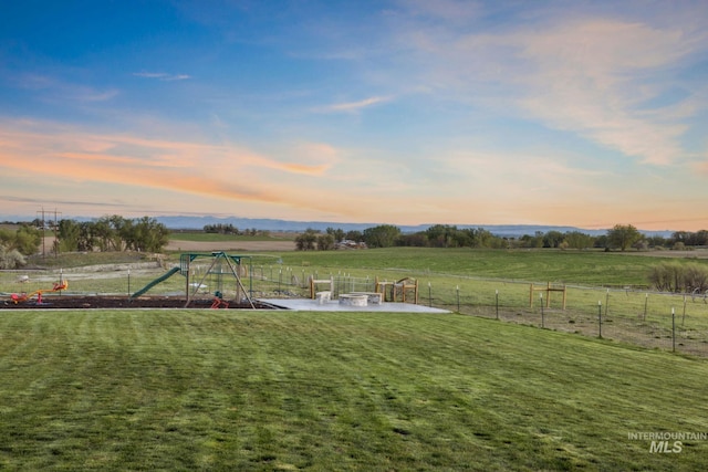 17293 Goodson Rd, Caldwell, ID 83607 - yard at dusk with a patio area, a rural view, a playground, and fence