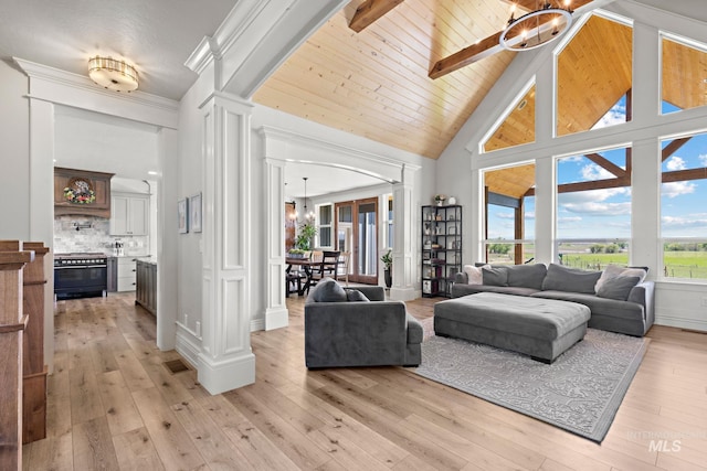 17293 Goodson Rd, Caldwell, ID 83607 - living area featuring wood ceiling, light wood-style flooring, an inviting chandelier, ornate columns, and high vaulted ceiling