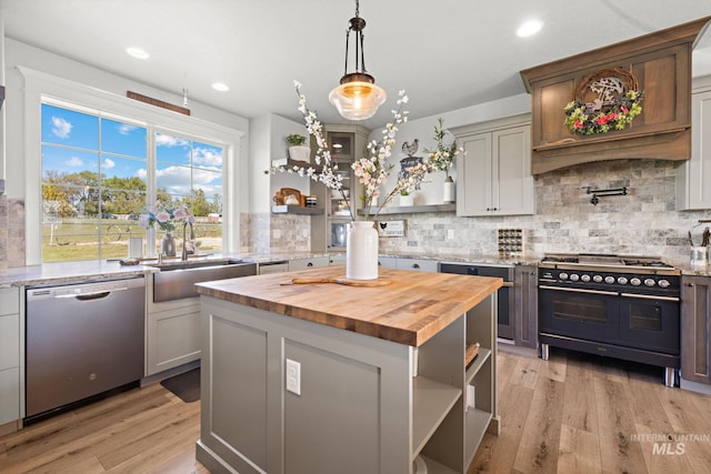 17293 Goodson Rd, Caldwell, ID 83607 - kitchen with wood counters, stainless steel dishwasher, double oven range, open shelves, and a sink