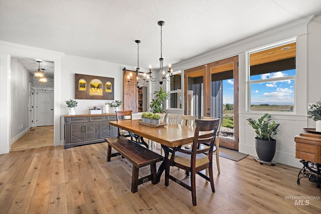 17293 Goodson Rd, Caldwell, ID 83607 - dining space with a chandelier, light wood-type flooring, and baseboards