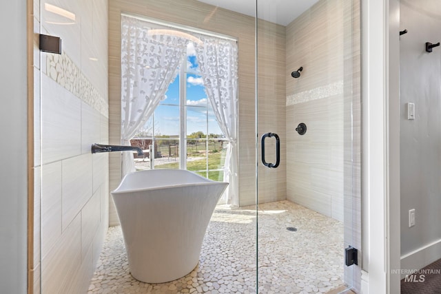 17293 Goodson Rd, Caldwell, ID 83607 - full bath featuring tile walls, a freestanding tub, and a shower stall