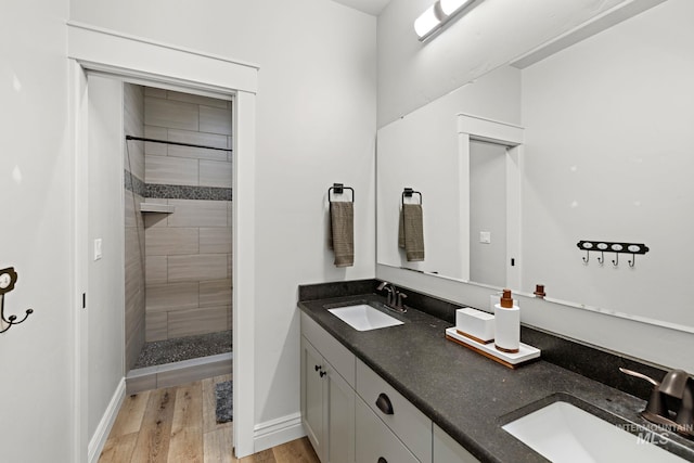 17293 Goodson Rd, Caldwell, ID 83607 - bathroom with tiled shower, a sink, and wood finished floors
