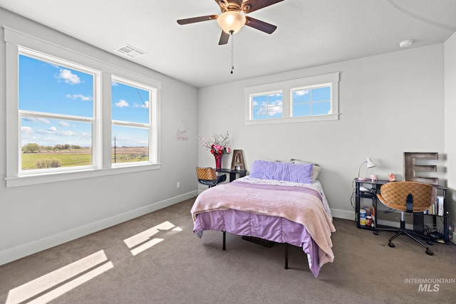 17293 Goodson Rd, Caldwell, ID 83607 - bedroom with carpet floors, visible vents, baseboards, and a ceiling fan
