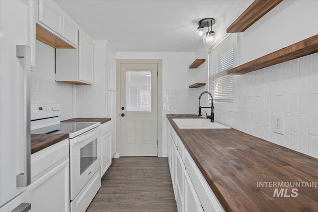 kitchen with white electric range, butcher block countertops, dark wood-style flooring, white cabinetry, and open shelves