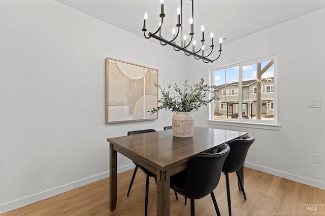 dining room with a notable chandelier and light hardwood / wood-style floors