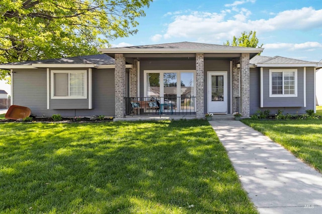 view of front of home featuring a front yard and brick siding